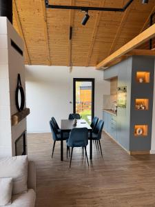 a kitchen and dining room with a table and chairs at Vamas Villa in Dobroselica