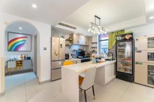 a kitchen with a table and a rainbow painting on the wall at 杭州西湖月上兰湾民宿 in Hangzhou