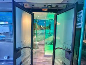 a room with glass doors with a view of the ocean at Unusual converted bus for couples or families in Berck-sur-Mer