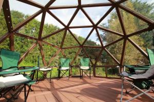 a group of chairs sitting inside of a glass igloo at Sea & Mountain Views Retreat on Rosemary Farm in Waihi