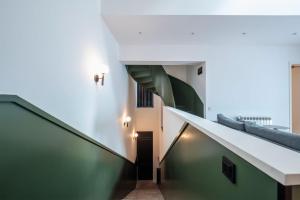 a staircase in a building with green and white walls at Artifact Apart Hotel in Tbilisi City