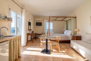 a hotel room with a bed and a table and chairs at Aeolos Hotel in Koufonisia