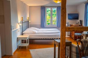 a small bedroom with a bed and a window at Hotel Obertor in Ravensburg