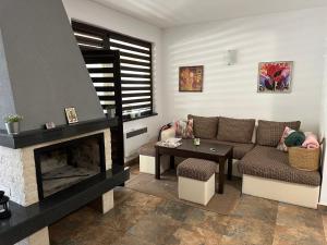 a living room with a couch and a fireplace at Марковската къща in Oreshak +15 photos