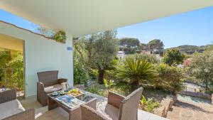 a view from the balcony of a house with a table and chairs at Sardinianworld - Da Tatà -Santa Caterina di Pittinuri in Santa Caterina