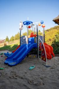 a playground with a blue slide at Osada Na Ochodzitej in Koniaków