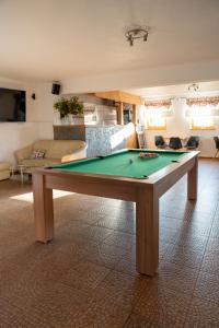 a living room with a pool table in a room at Osada Na Ochodzitej in Koniaków +34 photos