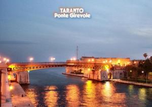 a bridge over a river in a city at night at Casa Vacanze del Salento in Sava +21 photos