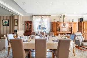 a dining room with a large table and chairs at La Mansardière in Cancale