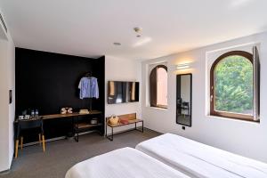a bedroom with a bed and a desk in it at Hotel Melibea by gaiarooms in Salamanca