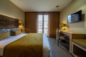 a hotel room with a bed and a desk at Hotel Constanza in Barcelona +61 photos