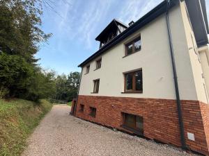 a white building with windows on the side of it at sPokoje in Wieliczka