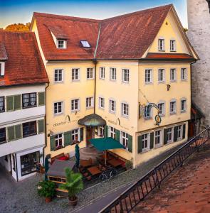 a large yellow building with a table in front of it at Hotel Obertor in Ravensburg