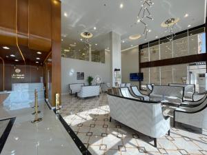 a lobby with chairs and tables in a building at أي رووم سويتس للشقق المخدومة in Sakakah