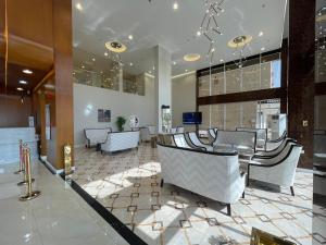 a lobby with a bunch of chairs in a building at أي رووم سويتس للشقق المخدومة in Sakakah
