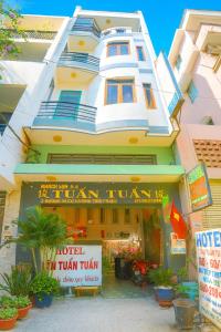 a building with a hotel in front of it at Tân Tuấn Tuấn Hotel in Ho Chi Minh City