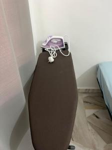 a purple phone sitting on top of a toilet at Mus Lim Homestay Aqil Bandar Puncak Alam in Bandar Puncak Alam