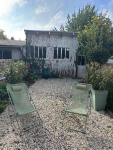 two lawn chairs sitting in front of a house at La Terasse de Tours in Tours