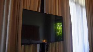a flat screen tv hanging on a curtain at Hidden Gardens Resort, Davao in Davao City