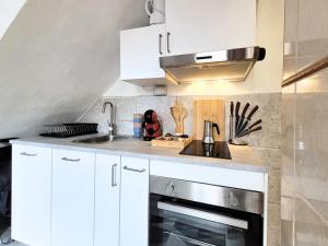 La cuisine est équipée de placards blancs et d'un four en acier inoxydable. dans l'établissement René, à Los Realejos