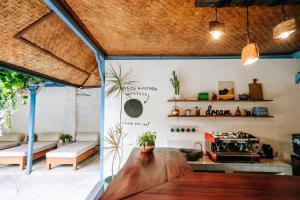 a room with a wooden table and a stove at Sanur House in Sanur