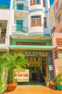 a building with a sign in front of it at Tân Tuấn Tuấn Hotel in Ho Chi Minh City +3 photos