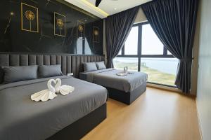 a bedroom with two beds with swans on them at Danga Bay The Lexus Seaview 3BR 8Pax Balcony by Our Stay in Johor Bahru +58 photos
