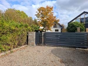a black fence in front of a house at Koci Dom in Wieliczka +4 photos