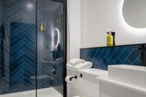 a bathroom with a shower and a sink at Station Suites Aparthotel in Middlesbrough