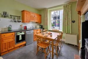 a kitchen with a table and chairs and a window at Finest Retreats - Bod Gwynedd in Penmachno