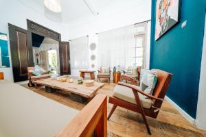 a living room with a wooden table and chairs at Sanur House in Sanur