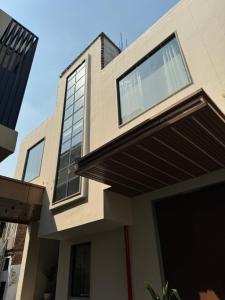 a house with a large window on top of it at Modern Hotel Restaurant and Bar in Mathura