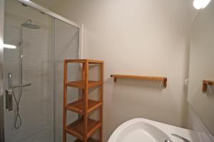 a bathroom with a shower and a toilet and a sink at Gîte Les Champs N°2 in Saint-Mathieu +24 photos