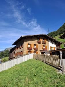 a house with a fence in front of it at Apartment Simone in Klösterle am Arlberg