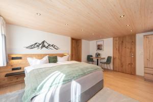 a bedroom with a bed and a wooden ceiling at Apartment Simone in Klösterle
