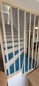a stairway with a blue and white carpet at Haus Martha in Ilići
