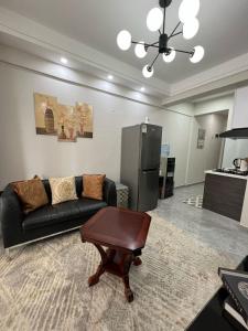 a living room with a couch and a table at Comfort Cove - One bedroom Apartment in Kilimani, Nairobi in Nairobi +10 photos