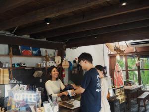 a group of people standing in a shop with a woman at Makai NAP, Thaimueang in Ban Lam Pi