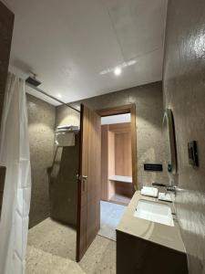 a bathroom with a sink and a shower at Modern Hotel Restaurant and Bar in Mathura +14 photos