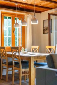 a dining room with a wooden table and chairs at Mountain Apartment - Hot Tub & Sunset Views in Axalp +65 photos