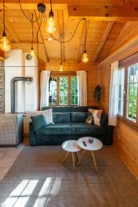 a living room with a couch and a table at Mountain Apartment - Hot Tub & Sunset Views in Axalp
