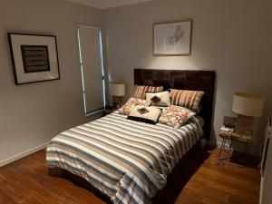 a bedroom with a large bed with a striped blanket at Hilltop Getaway in Ocean View +27 photos