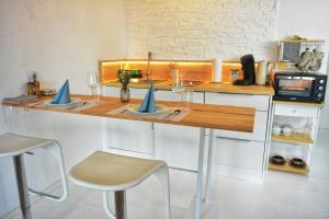 a kitchen with a counter with chairs and a sink at Apartment mitten in Rosenheim in Rosenheim +4 photos