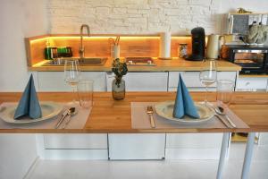 a table with two plates with napkins and wine glasses at Apartment mitten in Rosenheim in Rosenheim