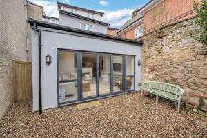 a building with a bench next to a building at Flat 1, 119 Northgate St - luxury 2 bedroom apartment apartment close to the town centre with paid parking close by in Bury Saint Edmunds