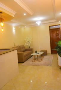 a living room with a couch and a table at Ann'sbammyline Serene homes in Ruiru +2 photos