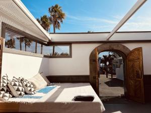 a bedroom with a bed and an open door at Casita Malvika in Costa Teguise