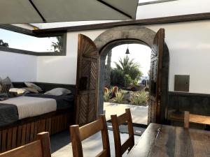 a bedroom with a bed and a table and chairs at Casita Malvika in Costa Teguise
