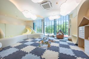 a childrens room with a checkered floor and large windows at The Title Legendary BangTao Beach by TropicLook in Bang Tao Beach +104 photos