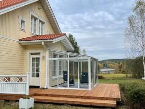een afgeschermde veranda in een huis met een terras bij Villa Koivurinne in Äänekoski